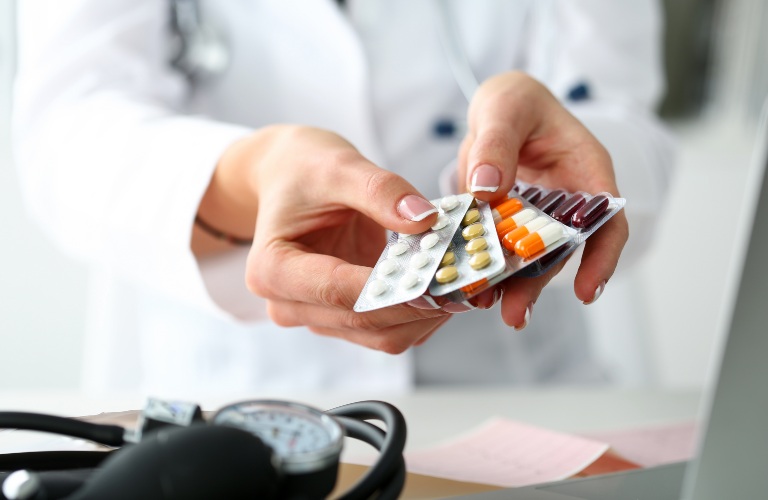 pills in a medical professional's hands