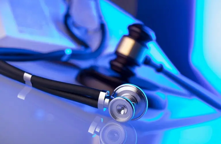 stethoscope with open legal book and gavel_s